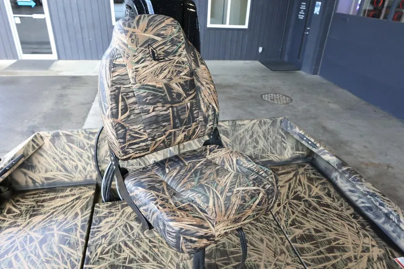 Slide: The Image of 2023 Lowe Roughneck 1760 Pathfinder boat seat with camouflage design in a showroom. - 10