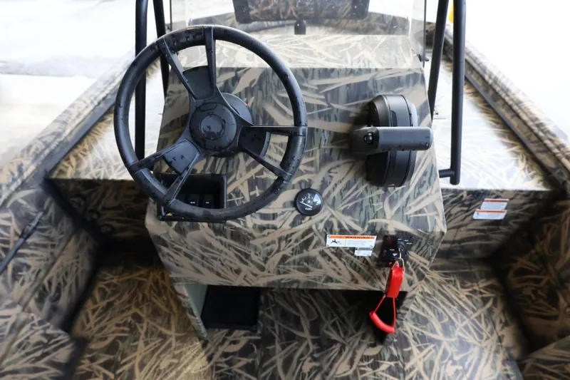 Slide: The Image of 2023 Lowe Roughneck 1760 Pathfinder boat console with camouflage design and steering wheel. - 11