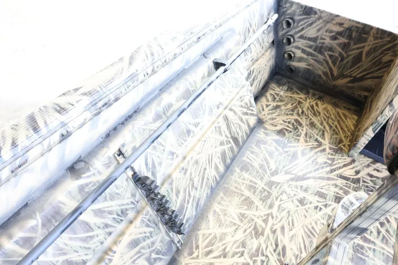 Slide: The Image of 2023 Lowe Roughneck 1760 Pathfinder interior with camouflage design, showcasing storage compartments. - 12