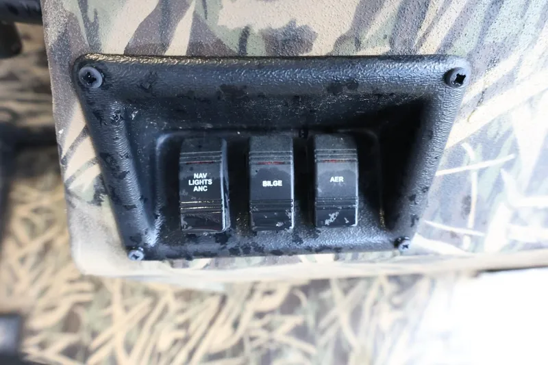 Slide: The Image of Control panel of 2023 Lowe Roughneck 1760 Pathfinder with switches for navigation, bilge, and aerator. - 13