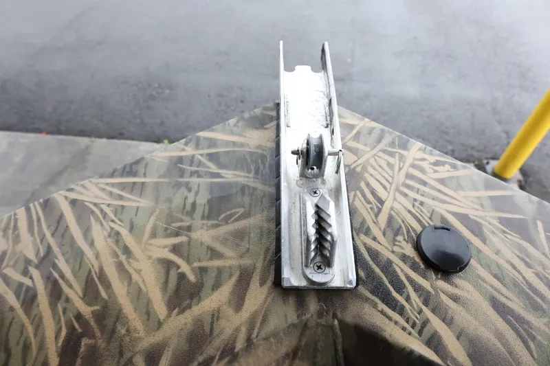 Slide: The Image of 2023 Lowe Roughneck 1760 Pathfinder boat with camouflage pattern and metal fixture. - 17