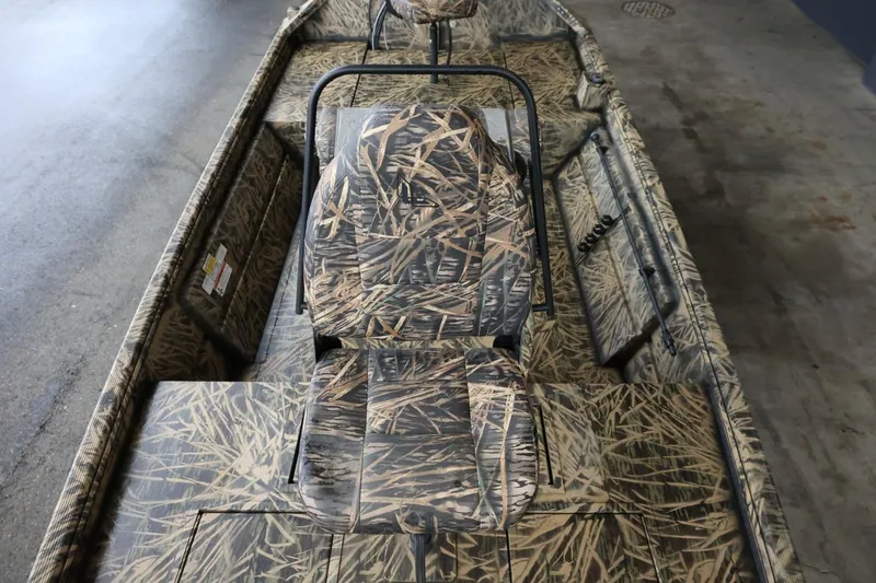 Slide: The Image of 2023 Lowe Roughneck 1760 Pathfinder boat with camouflage seating and interior design. - 18