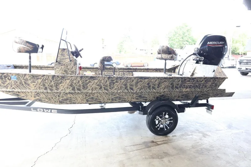 Slide: The Image of 2023 Lowe Roughneck 1760 Pathfinder boat with camouflage design and Mercury outboard motor. - 5