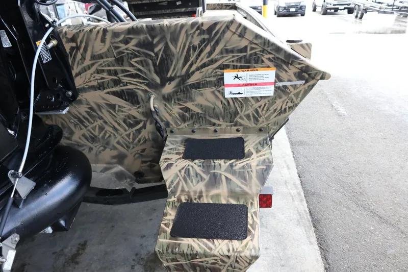 Slide: The Image of 2023 Lowe Roughneck 1760 Pathfinder boat with camouflage design and non-slip steps. - 9