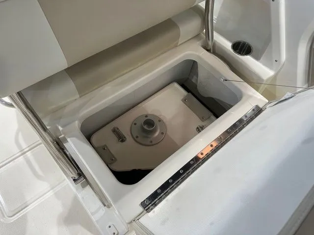 Slide: The Image of 2025 Boston Whaler 210 Vantage storage compartment with secure latch and sleek design. - 12