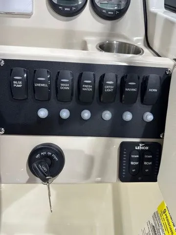 Slide: The Image of Control panel of a 2025 Boston Whaler 210 Vantage boat with various switches. - 13