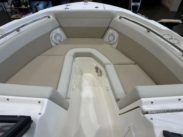 Slide: The Image of 2025 Boston Whaler 210 Vantage boat interior with beige seating and built-in speakers. - 4