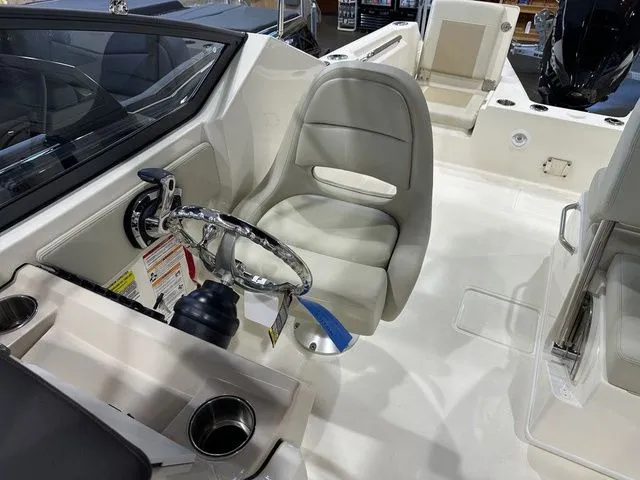 Slide: The Image of 2025 Boston Whaler 210 Vantage boat interior with steering wheel and seating area. - 7