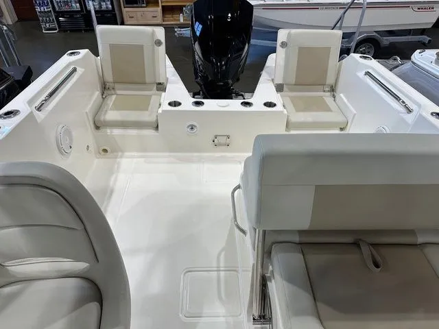 Slide: The Image of 2025 Boston Whaler 210 Vantage boat interior with seating and motor. - 8