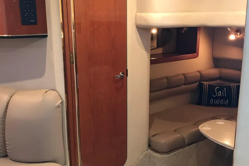Slide: The Image of Interior of 1998 Sea Ray 400 Sundancer yacht with cozy seating and "Sail Away" pillow. - 3