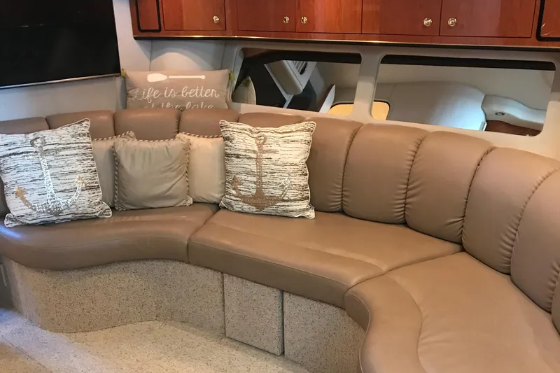 Slide: The Image of Luxurious interior of 1998 Sea Ray 400 Sundancer with plush seating and decorative pillows. - 4