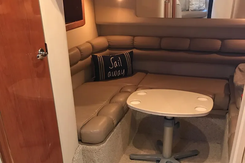 Slide: The Image of 1998 Sea Ray 400 Sundancer interior with cozy seating and "Sail Away" pillow. - 7