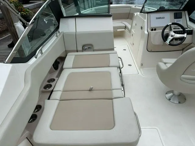 Slide: The Image of 2023 Boston Whaler 240 Vantage boat interior with beige seating and modern dashboard. - 11
