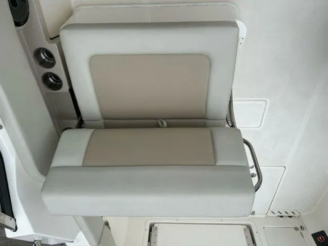 Slide: The Image of 2023 Boston Whaler 240 Vantage boat seat, beige and white upholstery, modern design. - 12