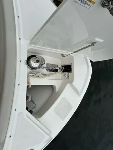 Slide: The Image of 2023 Boston Whaler 240 Vantage boat anchor compartment with open hatch. - 18