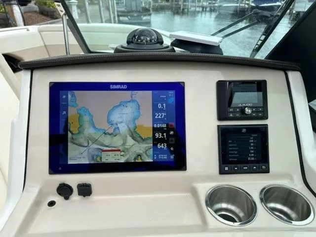 Slide: The Image of 2023 Boston Whaler 240 Vantage dashboard with navigation display and controls. - 21