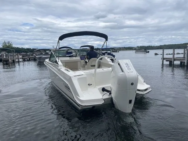 Slide: The Image of 2023 Boston Whaler 240 Vantage boat on water, featuring a powerful outboard motor. - 4