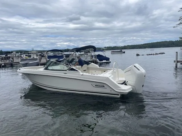 Slide: The Image of 2023 Boston Whaler 240 Vantage boat on a calm lake with cloudy skies. - 7