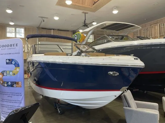 Slide: The Image of 2025 Cobalt R6 boat displayed indoors, featuring sleek design and modern amenities. - 1