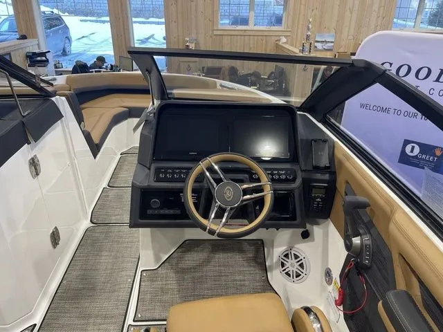 Slide: The Image of 2025 Cobalt R6 boat interior with modern dashboard and steering wheel in showroom. - 4