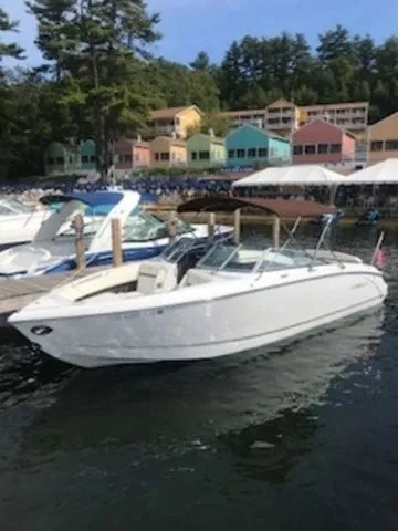 Slide: The Image of 2016 Cobalt R7 boat docked near colorful lakeside cabins. - 1