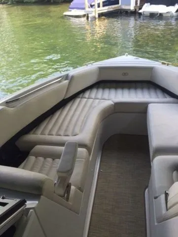 Slide: The Image of 2016 Cobalt R7 boat interior with cushioned seating on a calm lake. - 5