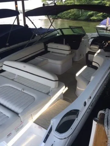 Slide: The Image of 2016 Cobalt R7 boat with white seating, docked by a serene lake. - 7