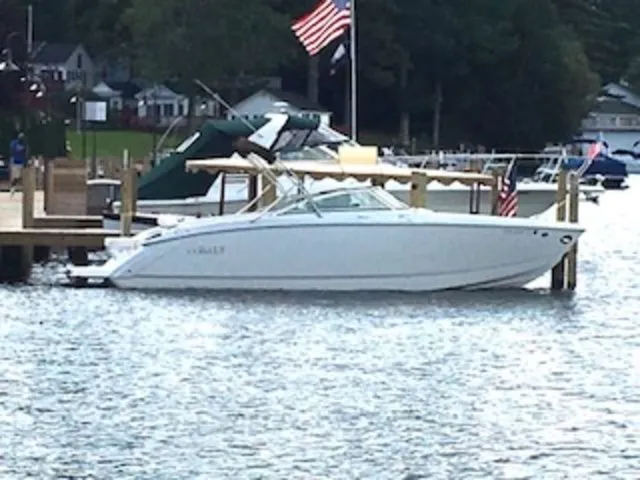 Slide: The Image of 2016 Cobalt R7 boat docked on a lake with American flags in the background. - 9