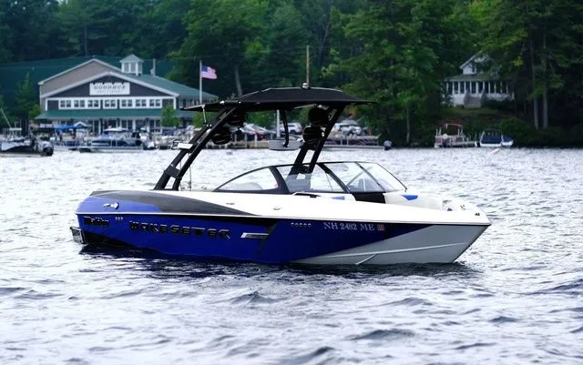 Slide: The Image of 2015 Malibu Wakesetter 22 VLX boat on a lake with a scenic background. - 6