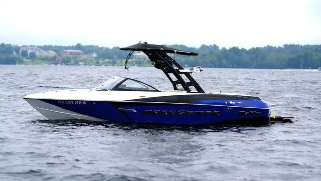 Slide: The Image of 2015 Malibu Wakesetter 22 VLX boat on a lake with scenic background. - 8