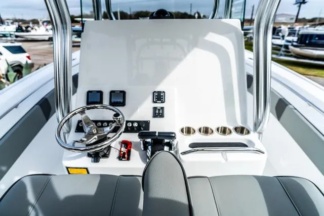 Slide: The Image of 2025 Cape Horn 31T boat console with steering wheel, gauges, and cup holders. - 10