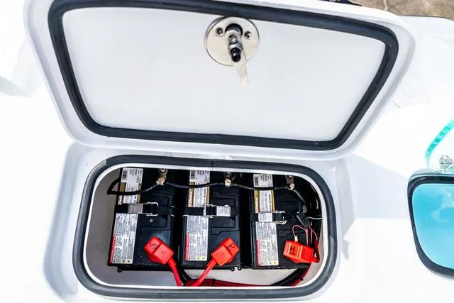 Slide: The Image of Battery compartment of 2025 Cape Horn 31T boat, featuring three batteries with red connectors. - 19