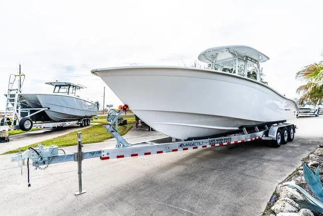 Slide: The Image of 2025 Cape Horn 31T boat on trailer, parked outdoors, showcasing sleek design and modern features. - 3