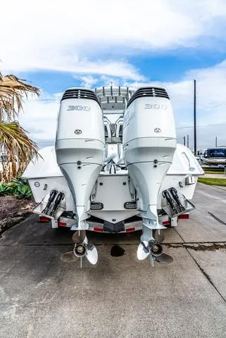 Slide: The Image of 2025 Cape Horn 31T boat with dual outboard engines, parked on a concrete surface. - 4