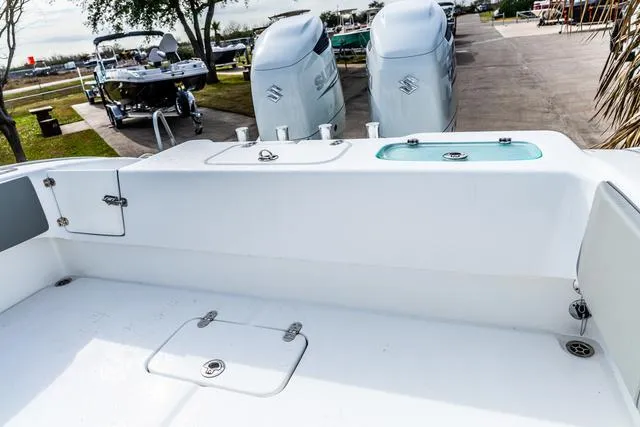 Slide: The Image of 2025 Cape Horn 31T boat with dual Suzuki outboard engines, docked outdoors. - 9