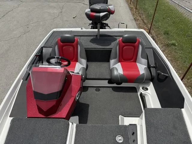 Slide: The Image of 2019 Ranger Z175 boat interior with red and gray seats, steering wheel, and console. - 12