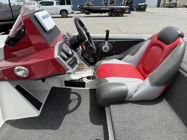 Slide: The Image of 2019 Ranger Z175 boat cockpit with red and gray seating, steering wheel, and dashboard controls. - 14