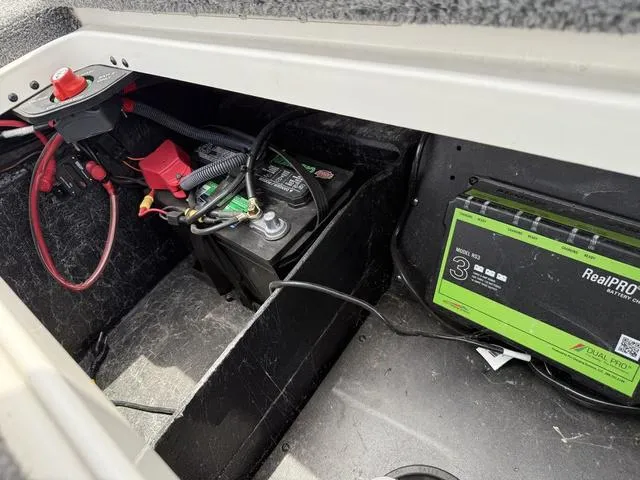 Slide: The Image of Battery compartment of 2019 Ranger Z175 boat with wiring and charger. - 23