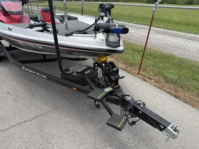 Slide: The Image of 2019 Ranger Z175 boat on trailer, parked on pavement near chain-link fence. - 4