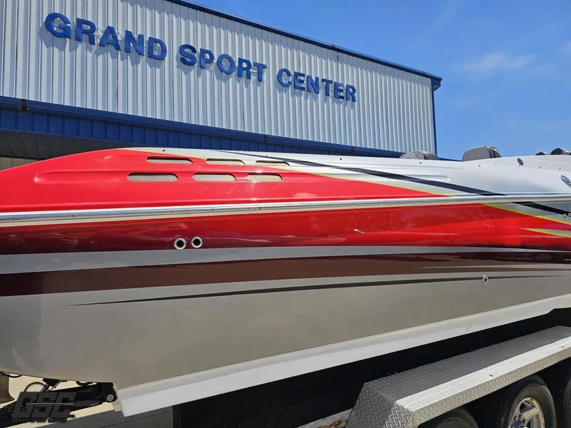Slide: The Image of 2007 Donzi 38 ZR boat in front of Grand Sport Center, featuring sleek red and white design. - 13