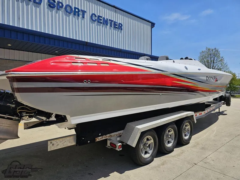 Slide: The Image of 2007 Donzi 38 ZR speedboat on trailer at a sports center, featuring vibrant red and white design. - 14