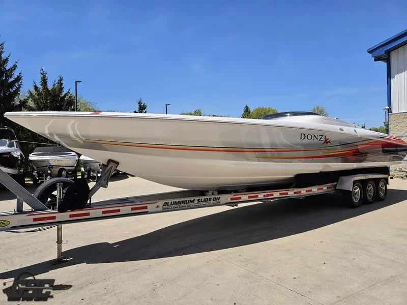 Slide: The Image of 2007 Donzi 38 ZR speedboat on trailer, sleek design, parked outdoors. - 18