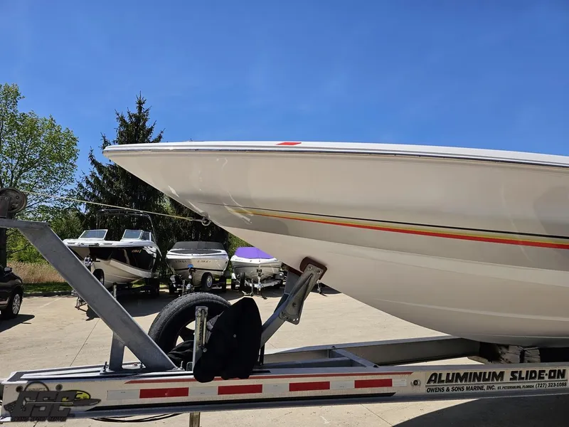 Slide: The Image of 2007 Donzi 38 ZR speedboat on trailer, parked outdoors under clear blue sky. - 19