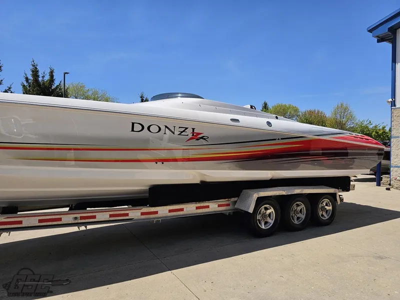 Slide: The Image of 2007 Donzi 38 ZR speedboat on trailer, sleek design with vibrant red and orange accents. - 21