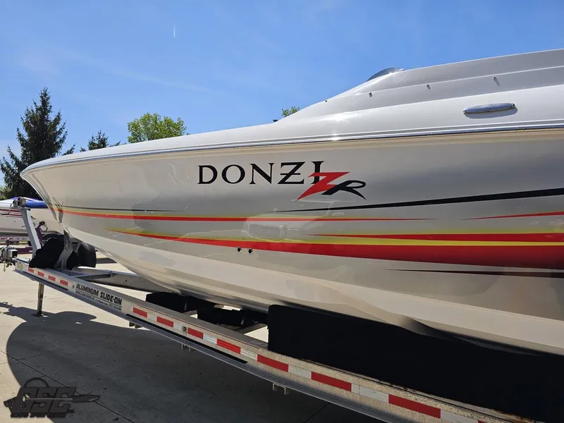 Slide: The Image of 2007 Donzi 38 ZR speedboat on trailer, showcasing sleek design and vibrant graphics. - 24