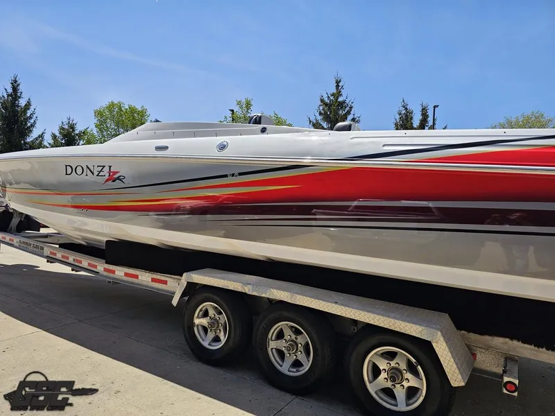 Slide: The Image of 2007 Donzi 38 ZR speedboat on a trailer, featuring sleek red and white design. - 26