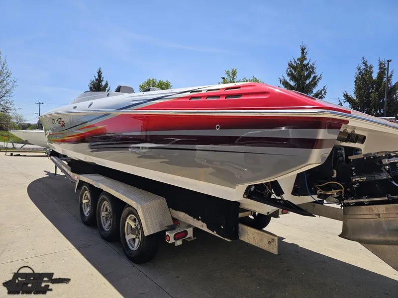 Slide: The Image of 2007 Donzi 38 ZR speedboat on trailer, featuring sleek red and white design. - 28