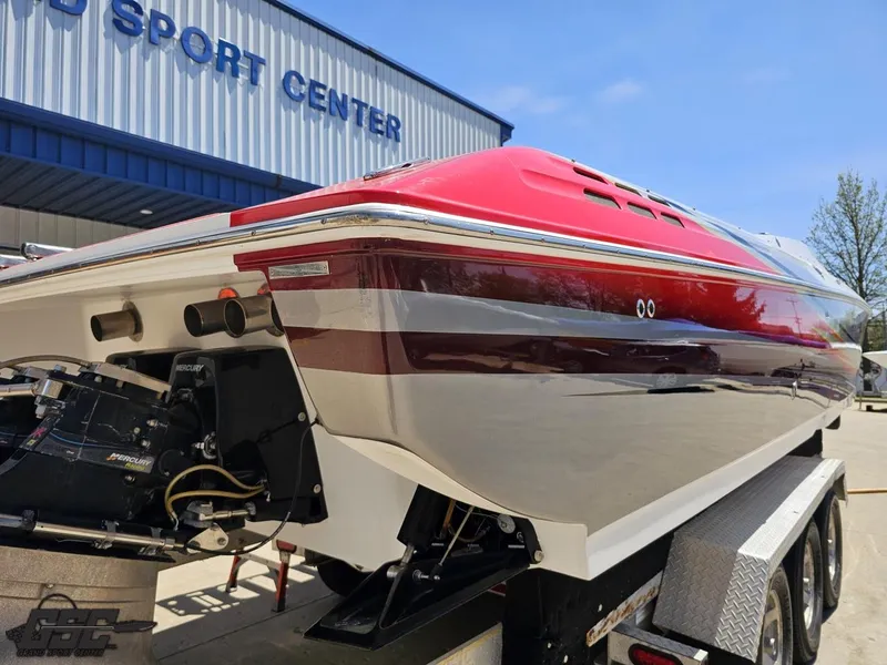 Slide: The Image of 2007 Donzi 38 ZR speedboat with red and white design on a trailer at a sport center. - 33