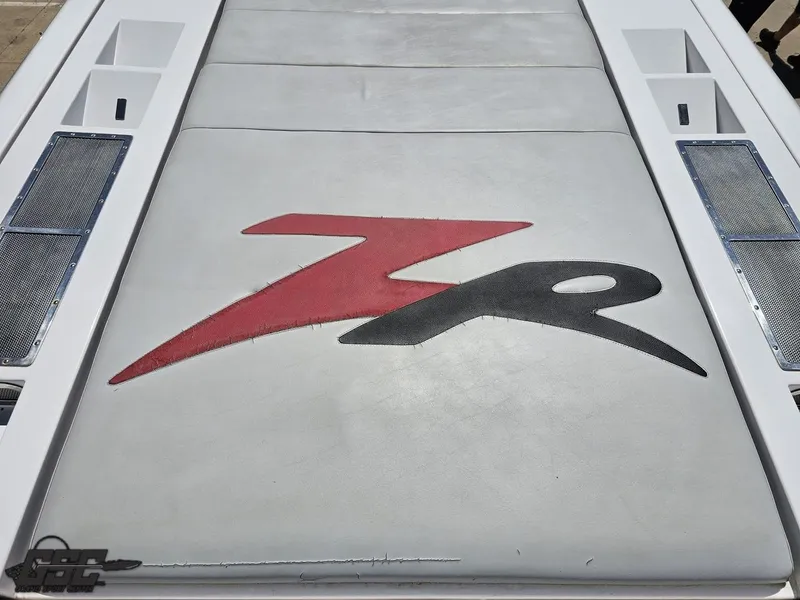 Slide: The Image of 2007 Donzi 38 ZR boat engine cover with red and black logo design. - 36