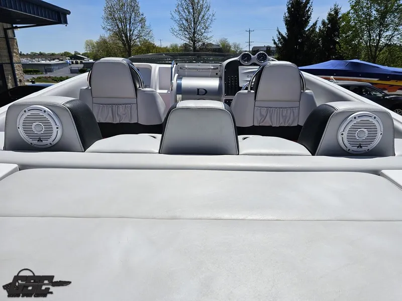 Slide: The Image of 2007 Donzi 38 ZR boat interior with white seating and speakers, under clear blue sky. - 44